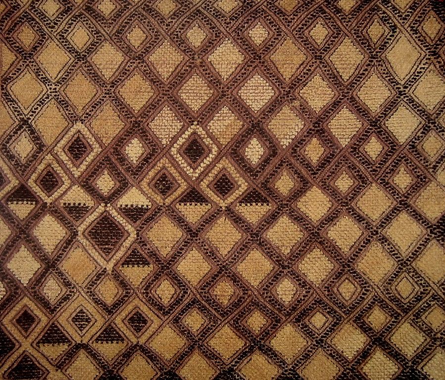 A image of a kasai velvet textile, woven in a diamond pattern in cream and black