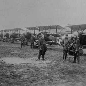 German soldiers from WWI standing in front of airplanes preparing to fly and air raid over Paris