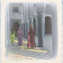 An image on the cover of Dreams of Trespass featuring three women in Moroccan dress walking away down a hall decorated with aniconic ornament.